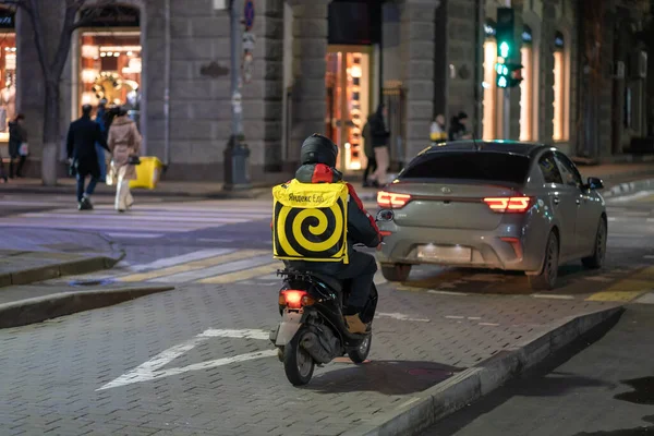 Krasnodar, Russia - January 03 2022: Yandex food delivery boy on scooter with isothermal food case — стоковое фото