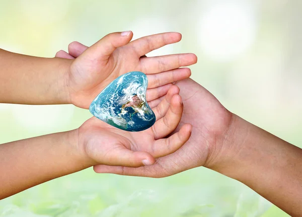 concept of saving the world. The heart of the world in the hands of children and mothers.