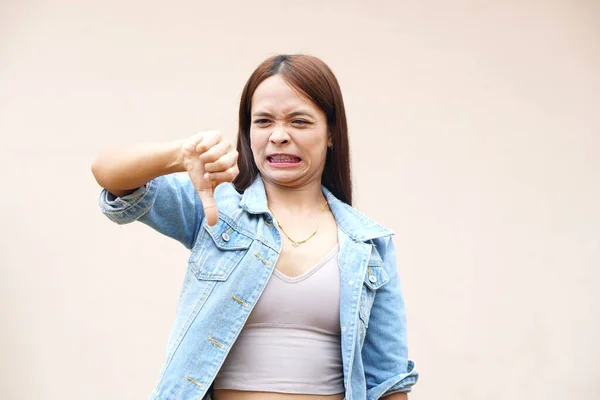 Asian woman raising hand to dislike
