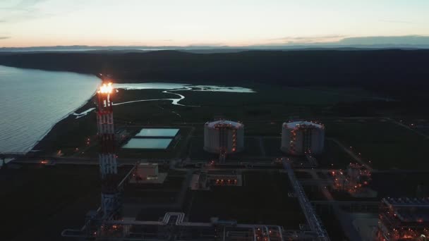 En un día de verano, enormes petroleros se abastecen de gas en el sur de la isla de Sakhalin desde una planta de GNL para su transporte a otros países. — Vídeo de stock