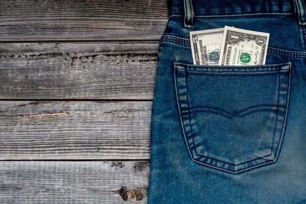 Dollar Biljetten Achterzak Van Jeans Een Houten Tafel Achtergrond — Stockfoto