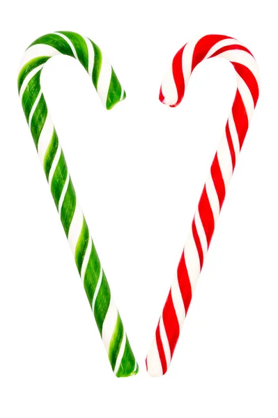 Geleneksel Noel şekeri beyaz arka planda izole edilmiş kırmızı, yeşil ve beyaz bir çubuk şeklinde..