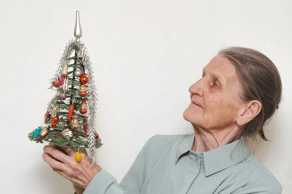 Lonely Old Elderly Woman Holds Small Christmas Tree Decorated Glass — Photo