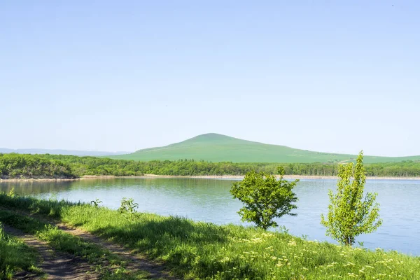 Tambukan forest lake on the background of a green mountain in Pyatigorsk . The nature of Russia and the Caucasus.