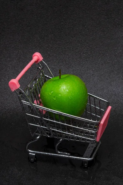 Een Gewassen Groene Appel Met Waterdruppels Een Winkelwagen Een Zwarte — Stockfoto