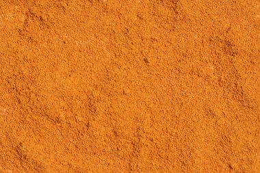 Portakal tozunun dokusu. Tam çerçevede kuru boyanın soyut arkaplanı.