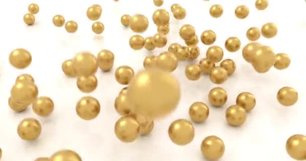 Golden balls falling on white background in slow motion — Stock Video