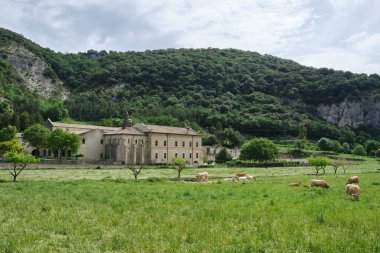 Monastery of Santa Mara la Real de Iranzu, abbey corridors with sculpted stone arches, Navarra, Spain.  clipart