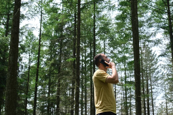 Young Man Using Mobile Phone Forest —  Fotos de Stock