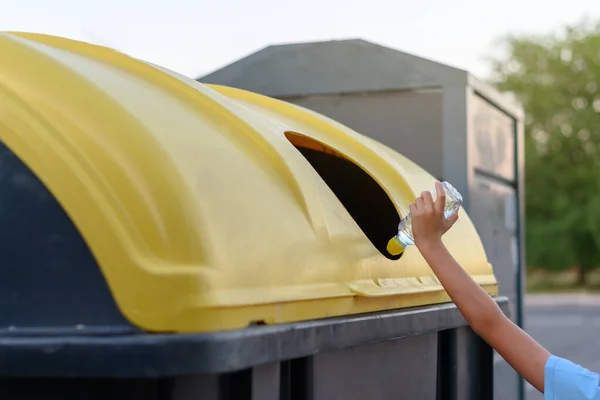 Child Hand Throws Plastic Bottle Yellow Recycling Garbage Can — Stock Photo, Image