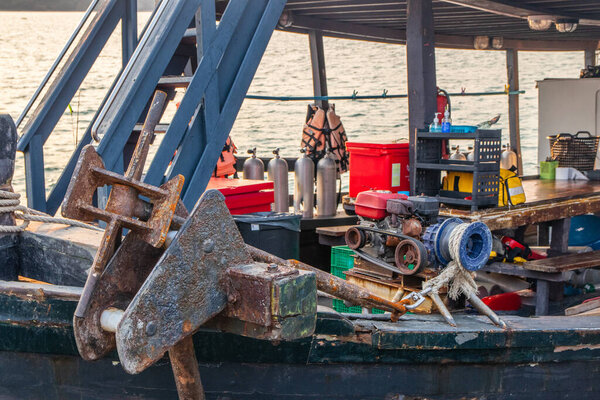 A diesel engine with a rope for raising and lowering a ship's anchor on the deck of a fishing boat