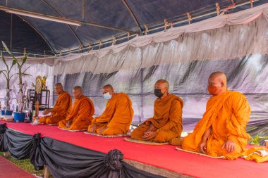 Food offering or food donation to Thai monks as part of a religious and Buddhist ritual in Thailand Southeast Asia