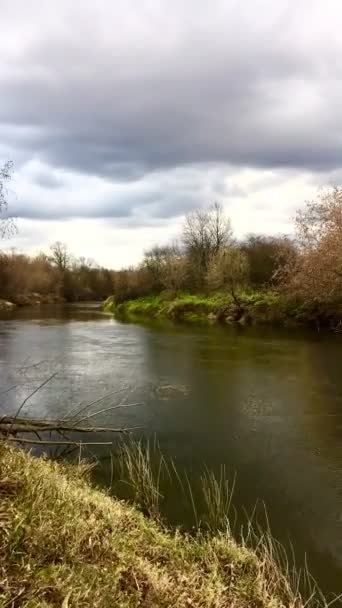 Dark clouds running over the river on an autumn day. Vertical video. Timelapse — Stock Video