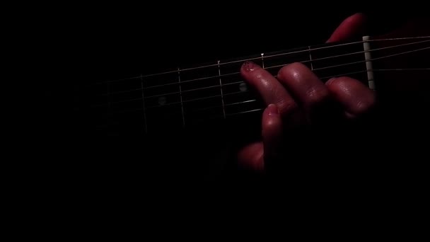 Hand clamping the chord on the strings of the guitar. Music. Art — Wideo stockowe