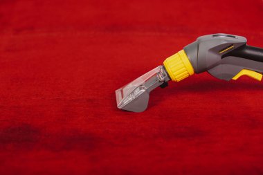 Temizlik için elektrikli cihaz kırmızı arkaplanda yatar, metin için boşluk