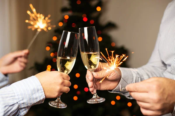 Couple Clinking Glasses Champagne Holding Sparklers Background Christmas Tree Celebrating Stock Photo