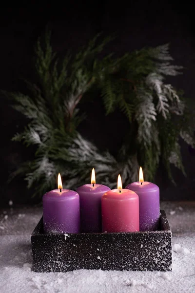 Čtyři Hořící Růžové Purpurové Adventní Svíčky Tmavé Dřevěné Krabici Sněhu — Stock fotografie