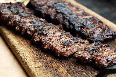 Pork Ribs Barbecue Grill on wooden cutting board, fried spare ribs, close-up.