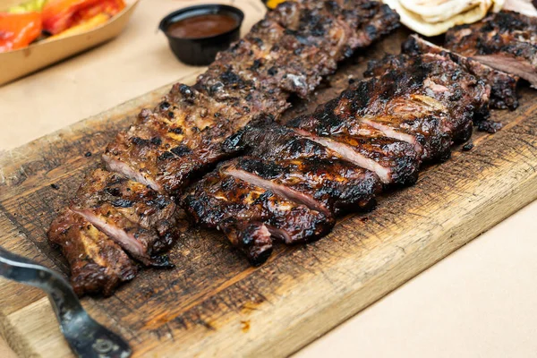 Fried spare ribs, Pork Ribs Barbecue Grill on wooden cutting board, close-up.