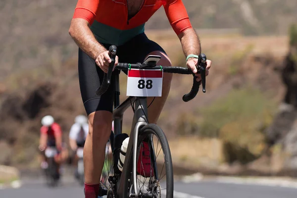 Cycling competition,cyclist athletes riding a race, climbing up a hill on a bicycle