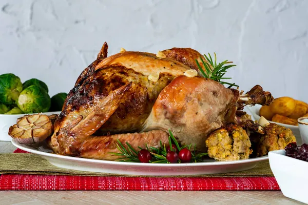 Traditional whole roasted Christmas turkey with apricot and pistachio stuffing, roast potatoes and cranberry sauce