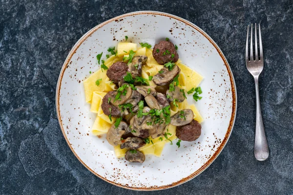 Venison meatballs with creamy mushroom sauce and pappardelle pasta - overhead view