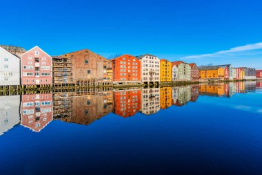 Norveç, Trondheim 'ın Brygge semtindeki Nidelva nehrinde yansıyan renkli ahşap evler.