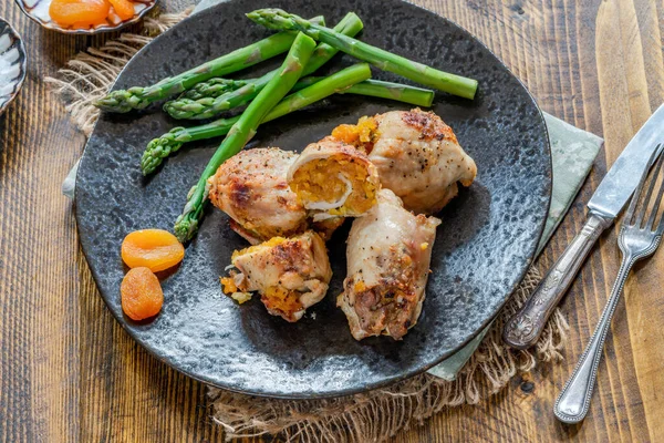 Chicken thighs with appricot stuffing and asparagus
