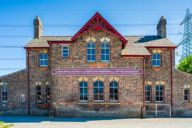 Old train station building in Llanfairpwllgwyngyllgogerychwyrndrobwllllantysiliogogogoch, the  longest town name in Europe, on the wall. Anglesey, Wales