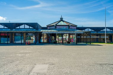 Llanfairpwllgwyngyllgogerychwyrndrobwllllantysiliogogogoch, Anglesey - JULY 10, 2022: Sign with 58 characters name of the town on the station platform. It's the longest place name in Europe
