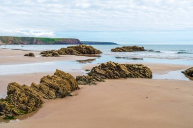 Marloes Sands Beach with rock formations at low tide, Wales