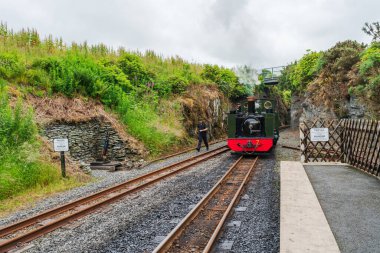 DEVIL'S BRIDGE, WALES - JULY 06, 2022: The Vale of Rheidol Railway steam engine train is waiting on the platform to take tourists on a 12 miles  scenic journey from Devil's Bridge to Aberystwyth