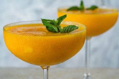 Frozen mango daiquiri with white rum garnished with fresh mint.