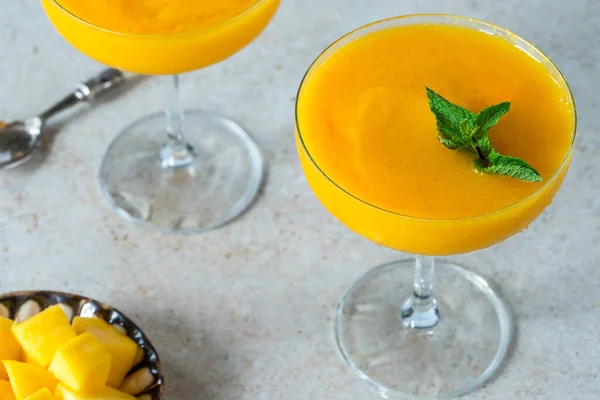 Frozen mango daiquiri with white rum garnished with fresh mint.