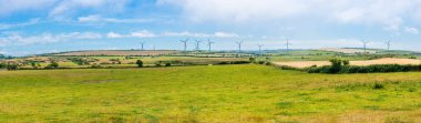 Panoramic view of rural landscape with wind turbines on the isle of Anglesey, Wales