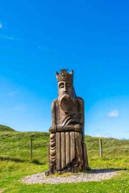 UIG, ISLE OF LEWIS, SCOTLAND - AUGUST 03, 2022: Wood carving of the King chess piece 'Lewis Chessmen' by  Stephen Hayward near Ardroil Beach, Uig Sands on the Isle of Lewis, Outer Hebrides, Scotland