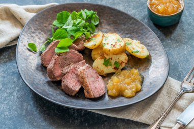 Roasted dack breast with fried potatoes and apple sauce