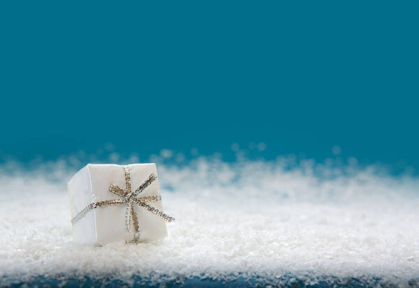 White christmas gift isolated on blue background.