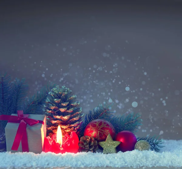 Rode adventskaars en kerstversiering op sneeuw. — Stockfoto