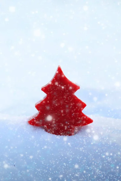 Christmas background with red fir tree on white snow. — Stock Photo, Image