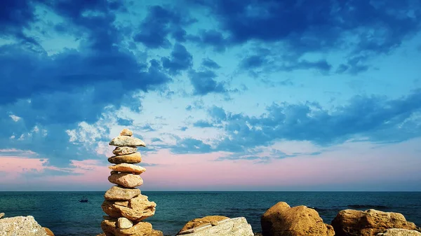 Piramide van stenen op het strand. Het concept van harmonie en ontspanning . — Stockfoto