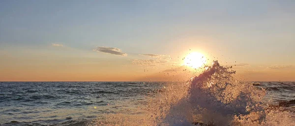 Pôr do sol colorido com grande sol sob as ondas do mar. — Fotografia de Stock