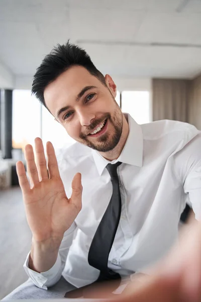 Empresario con ropa formal saludando con alguien mientras saluda —  Fotos de Stock