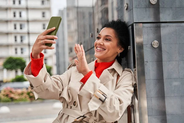Női integetett, miközben a videohívás okostelefonon valakivel sétálás közben — Stock Fotó