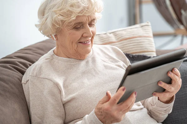 Mature woman holding digital tablet computer and calling by social distance — Stock Photo, Image