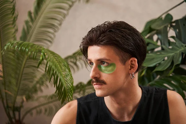 Serious male with mustache looking away with confident face