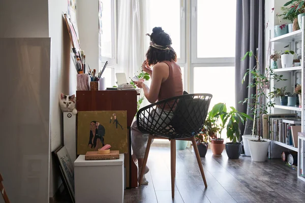 Běloška sedící u stolu a připravující si svůj denní make-up — Stock fotografie