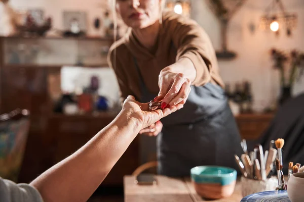 Female teacher giving something to her mature student at the master class — Stock Photo, Image