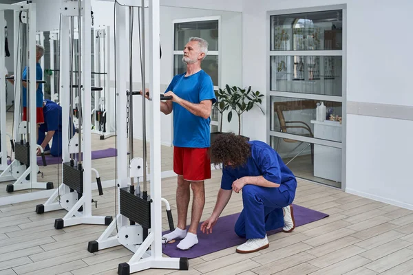 Senior Physical Therapy Patient Using Physiotherapy Equipment Rehabilitation Special Centre — 스톡 사진