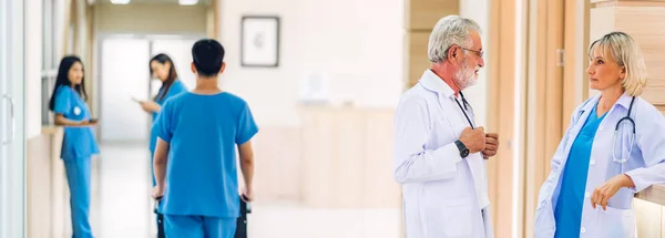 Group of professional medical doctor team work with stethoscope in uniform working discussing and talk walking in hospital.health medical care concept